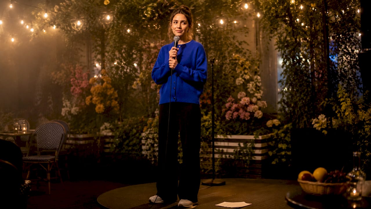 1781777449819_Open-mic-performer-on-small-cozy-stage En öppen scen där någon uppträder inför en liten, mysig publik.